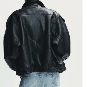 High collar jacket. Long sleeves finished in cuffs with shoulder tabs.